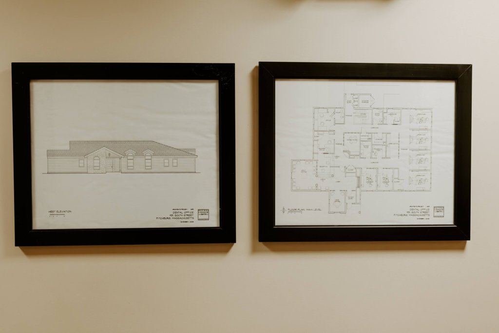 Framed architectural drawings displayed in the dental office