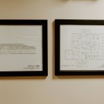 Framed architectural drawings displayed in the dental office