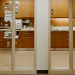 Dental office treatment area with private operatories and modern cabinetry
